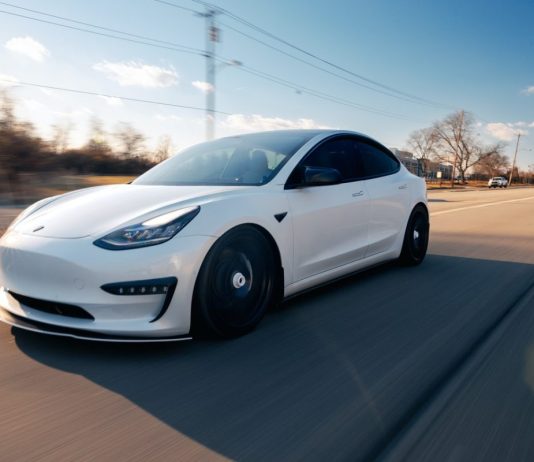 Tesla is the car of the future white-tesla-driving-on-the-road
