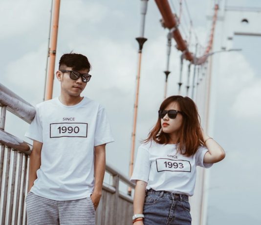 How Many Washes does Screen Printing Last a guy and a girl in white t-shirts with a print of the year of birth